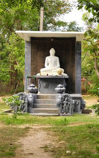 Statue against trees