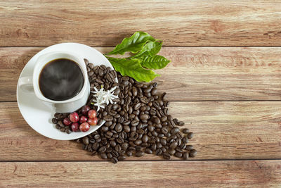 High angle view of coffee and leaves on table
