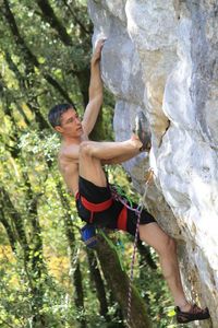 Full length of shirtless man on rock