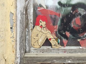 Close-up of woman relaxing on wall