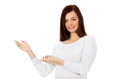 Portrait of a smiling young woman over white background