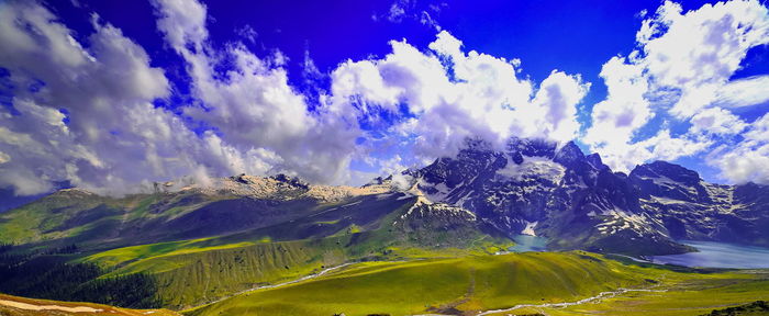 Panoramic view of mountains against blue sky