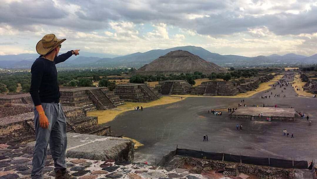 WOMAN STANDING ON MOUNTAIN