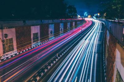 High angle view of light trails on highway at night