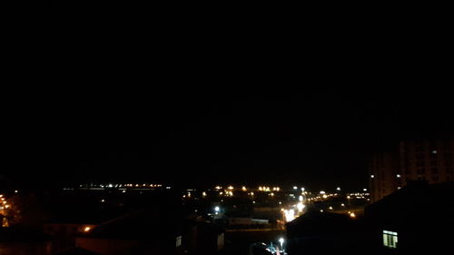 High angle view of illuminated buildings in city at night