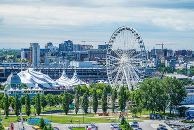 Ferris wheel in city against sky