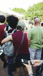 Rear view of people walking in park