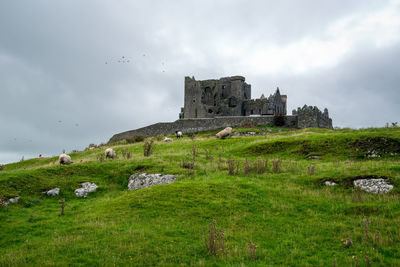 Historic building against cloudy sky