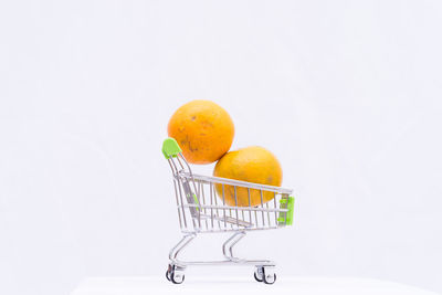 Orange fruit against white background