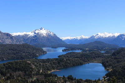 Scenic view of snowcapped mountains against clear blue sky