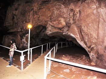 Side view of woman standing on staircase