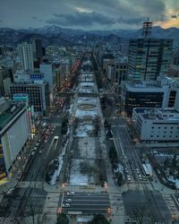 High angle view of city street and buildings against sky