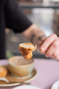 Cropped hand of woman having food