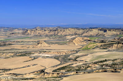 Aerial view of landscape against clear blue sky