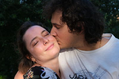 Portrait of couple kissing outdoors