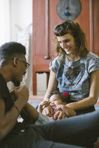 Happy mother and father with daughter at home