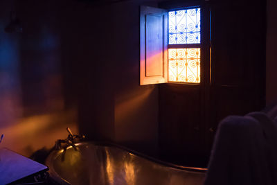 Close-up of illuminated lamp on table at home