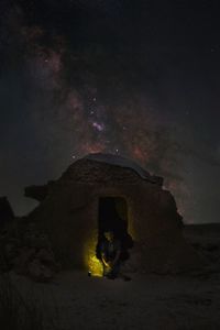 View of illuminated old castle against sky at night