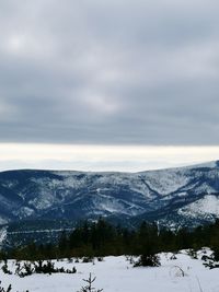 Scenic view of snow covered mountains against sky