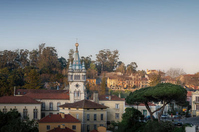 Buildings in city against clear sky