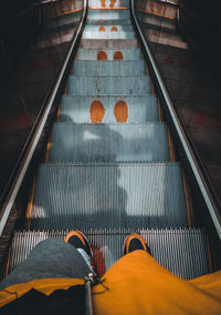 Low section of person on escalator