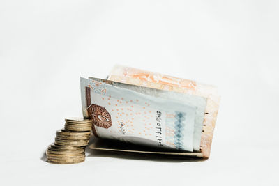 Close-up of coin stack against white background