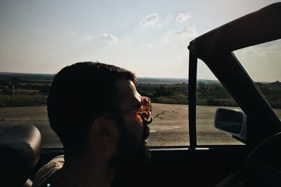 Man in sunglasses driving car