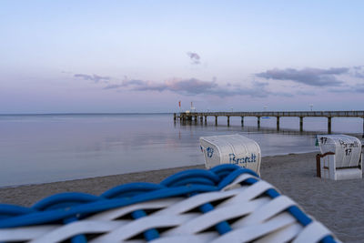 Pier over sea against sky during sunset