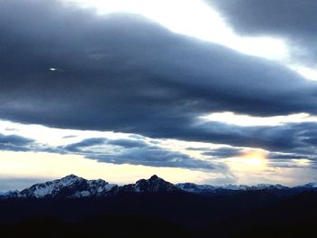 Scenic view of mountains against cloudy sky