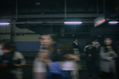 Blurred motion of people walking on illuminated subway station