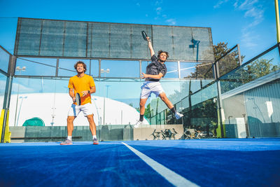 Low angle view of tennis players playing at court