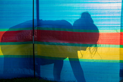 Shadow of girl on colorful fabric