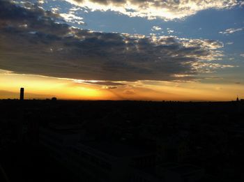 Silhouette of landscape against dramatic sky during sunset