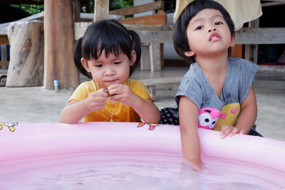 Cute sisters with wading pool