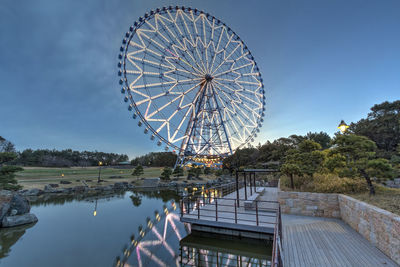 Low angle view of ferris wheel against sky