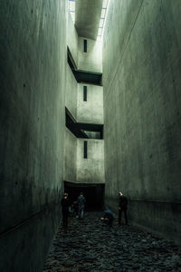 People walking on footpath amidst buildings in city