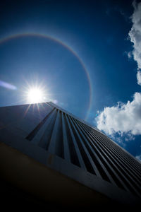 Low angle view of rainbow over blue sky