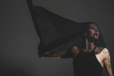 Young woman looking away over white background