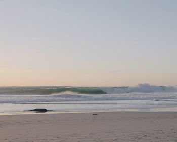 Scenic view of beach against sky during sunset