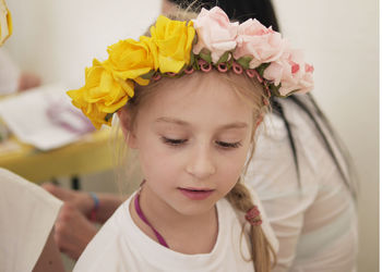 Close-up of young woman with flowers in hair