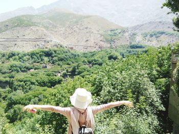 Rear view of woman standing on mountain