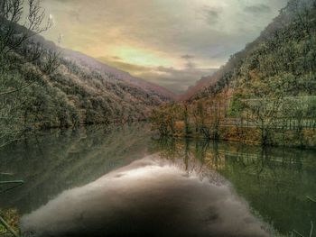 Scenic view of lake against cloudy sky