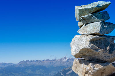 Stack of rocks against blue sky