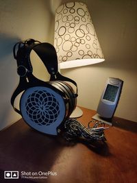 Close-up of electric lamp on table at home