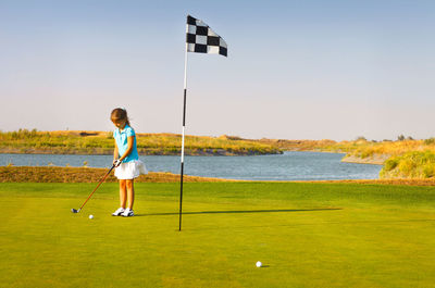 Full length of man standing on golf course