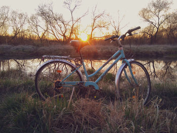 Bicycle on field during sunset