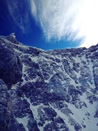 Low angle view of mountain against sky during winter