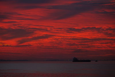 Scenic view of sea against romantic sky at sunset