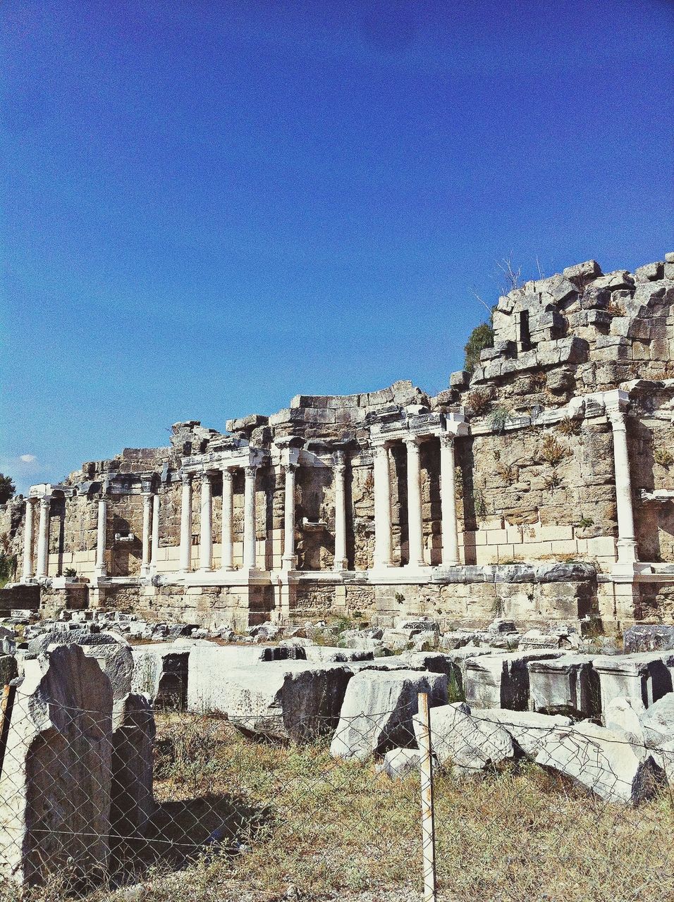 architecture, building exterior, built structure, blue, clear sky, history, low angle view, famous place, the past, travel destinations, old, sunlight, old ruin, city, sky, ancient, tourism, travel, copy space, day