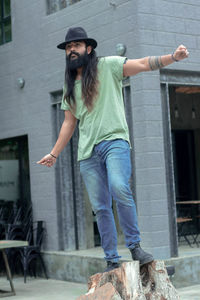 Full length portrait of man standing against built structure